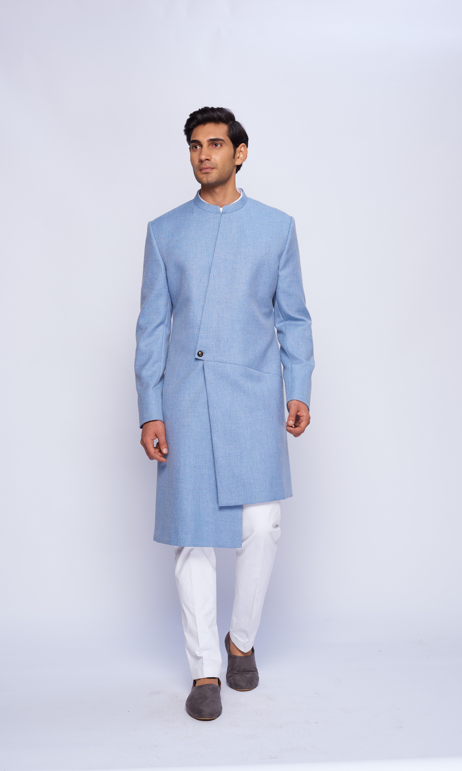 Powder blue indowestern asymmetric yoke sherwani paired with fitted pants