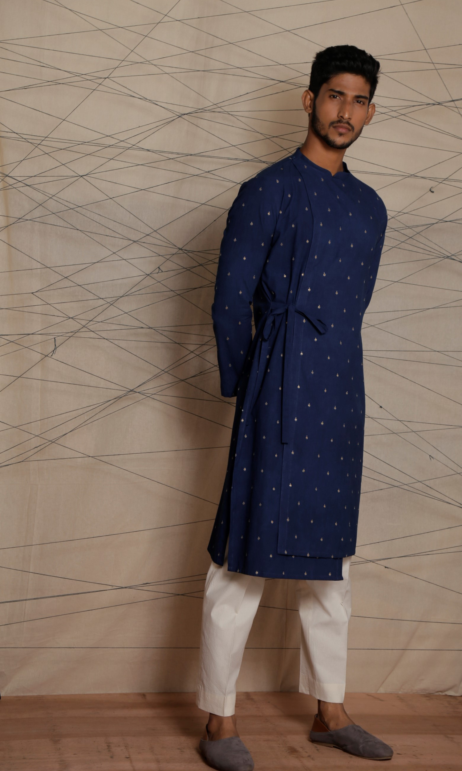 Dark blue asymmetrical tie up kurta with all over emb motifs