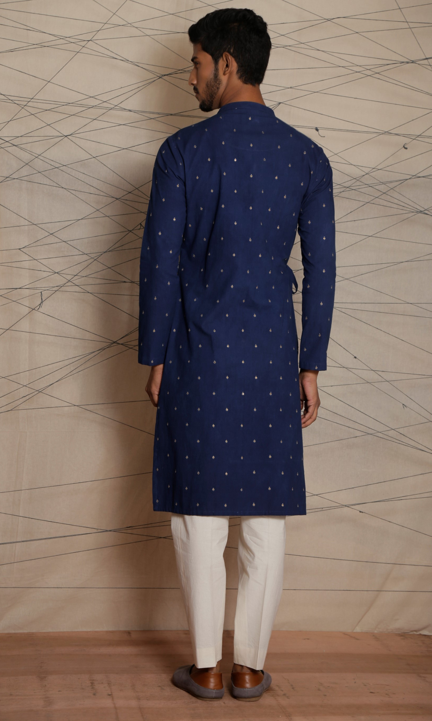 Dark blue asymmetrical tie up kurta with all over emb motifs
