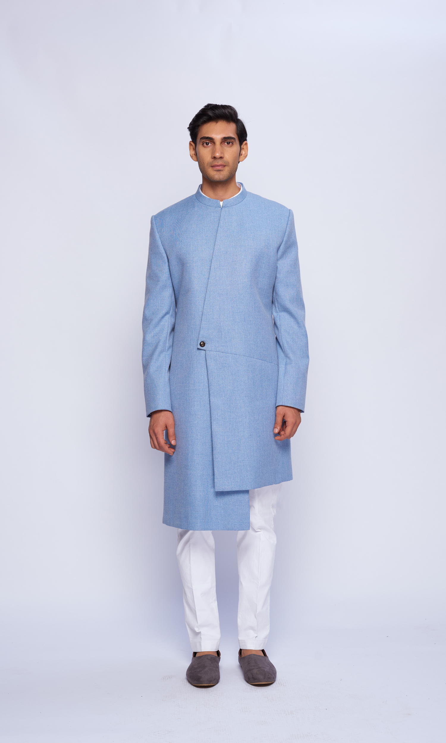 Powder blue indowestern asymmetric yoke sherwani paired with fitted pants