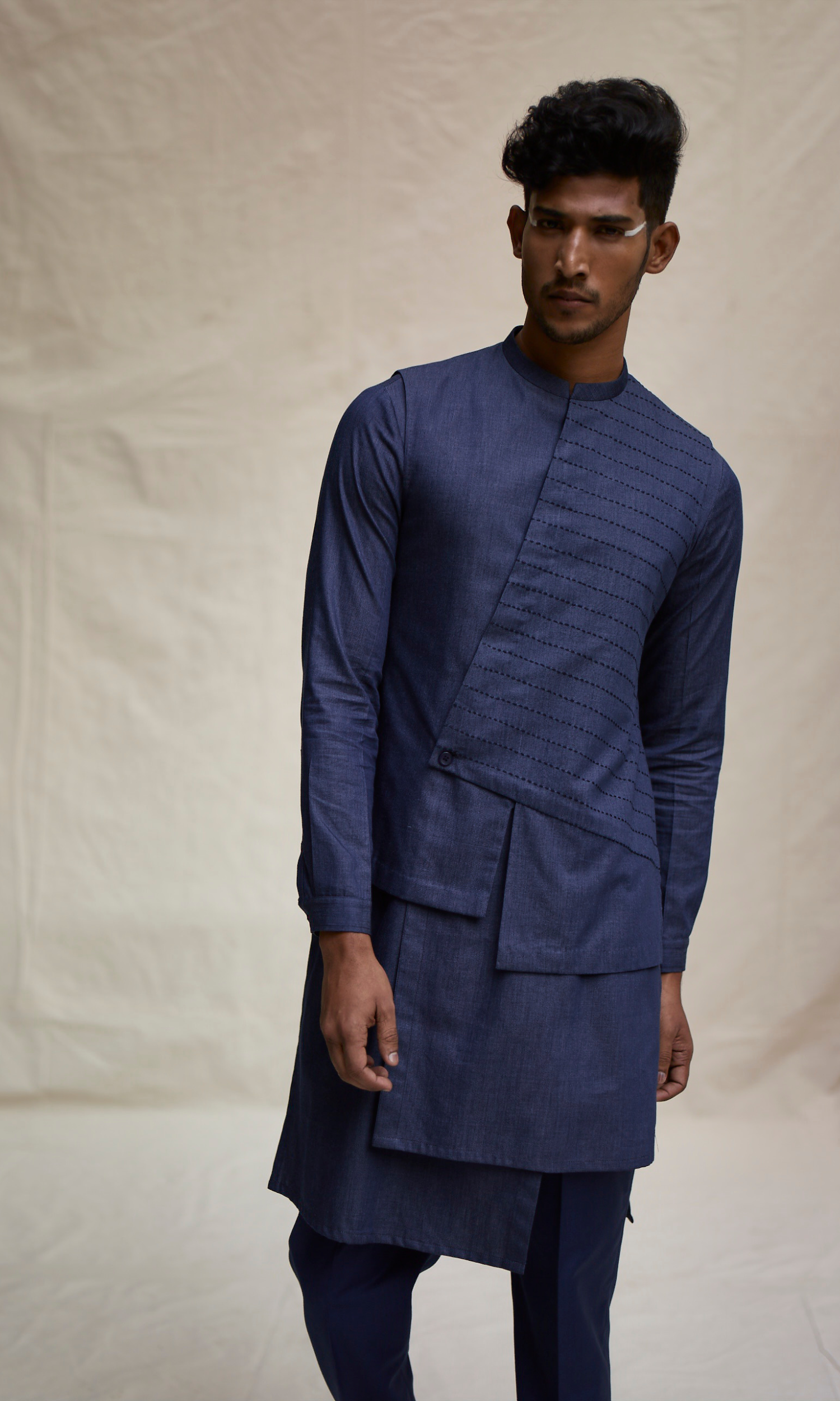 Dark blue asymmetric yoke bandi paired with tonal kurta and pants