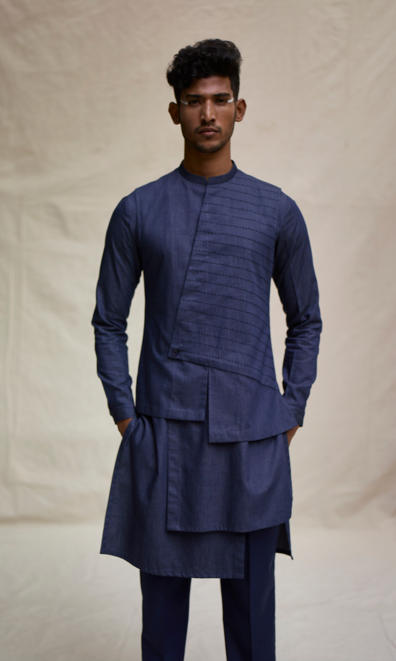 Dark blue asymmetric yoke bandi paired with tonal kurta and pants