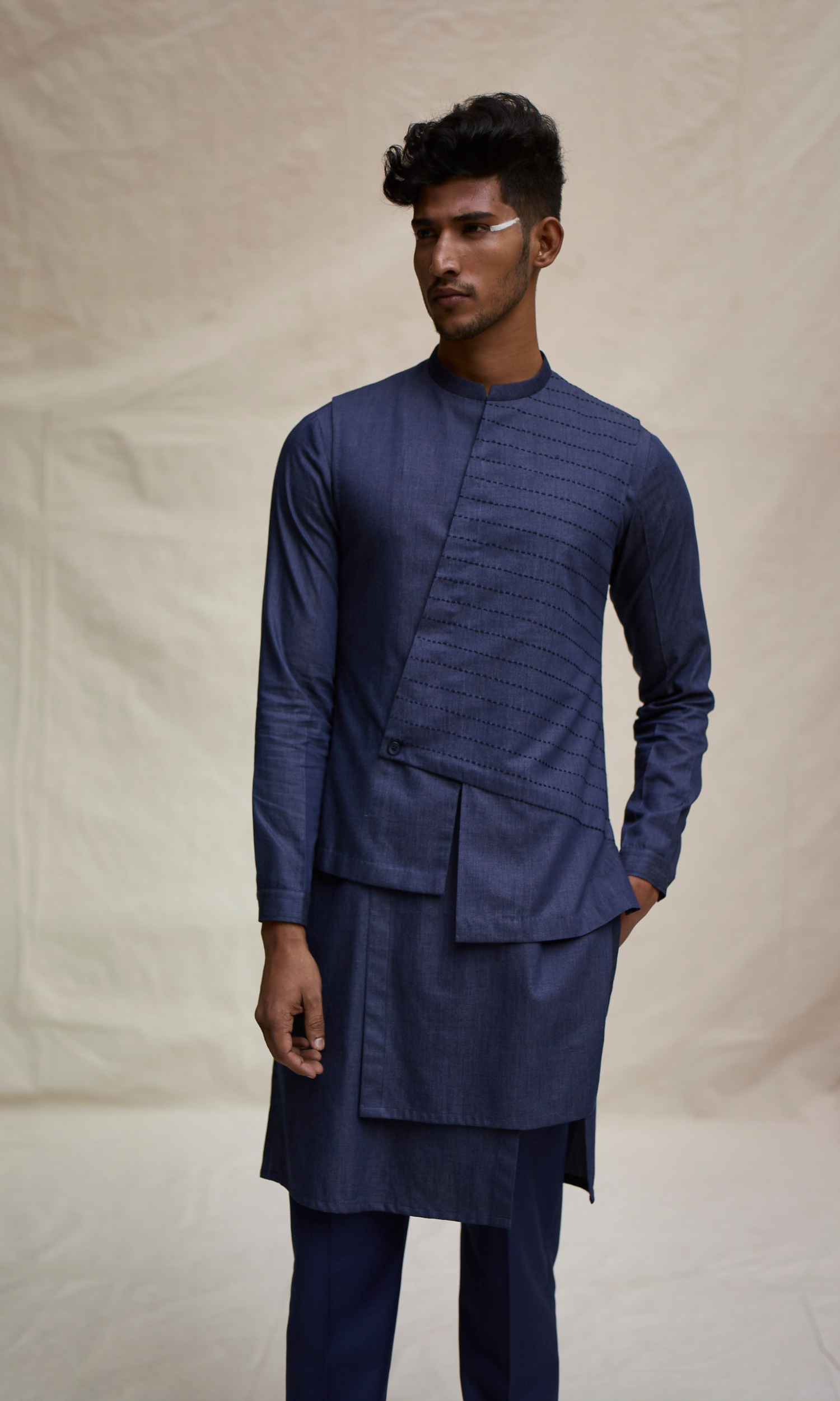 Dark blue asymmetric yoke bandi paired with tonal kurta and pants