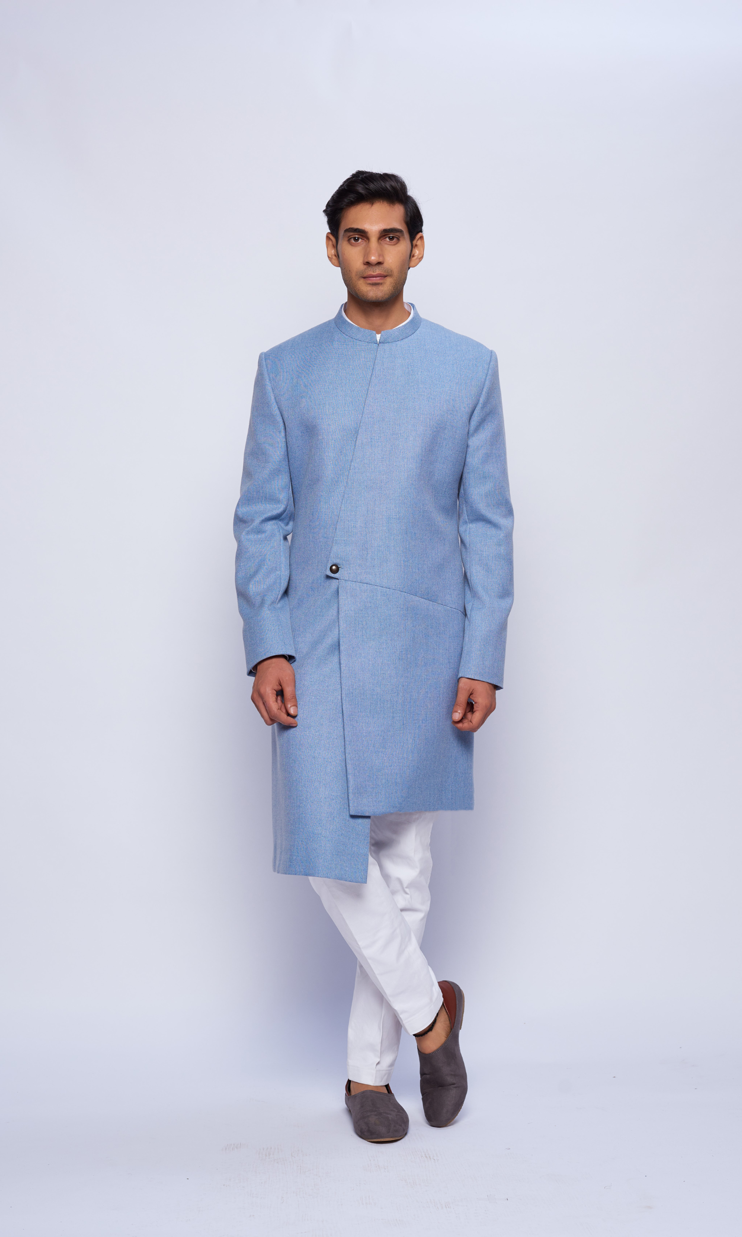 Powder blue indowestern asymmetric yoke sherwani paired with fitted pants