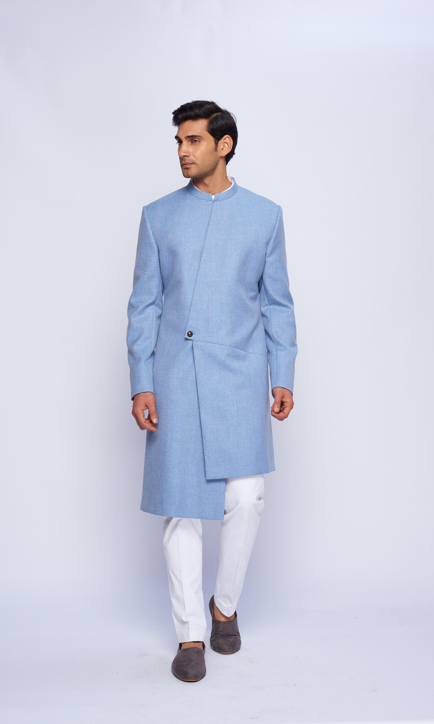 Powder blue indowestern asymmetric yoke sherwani paired with fitted pants