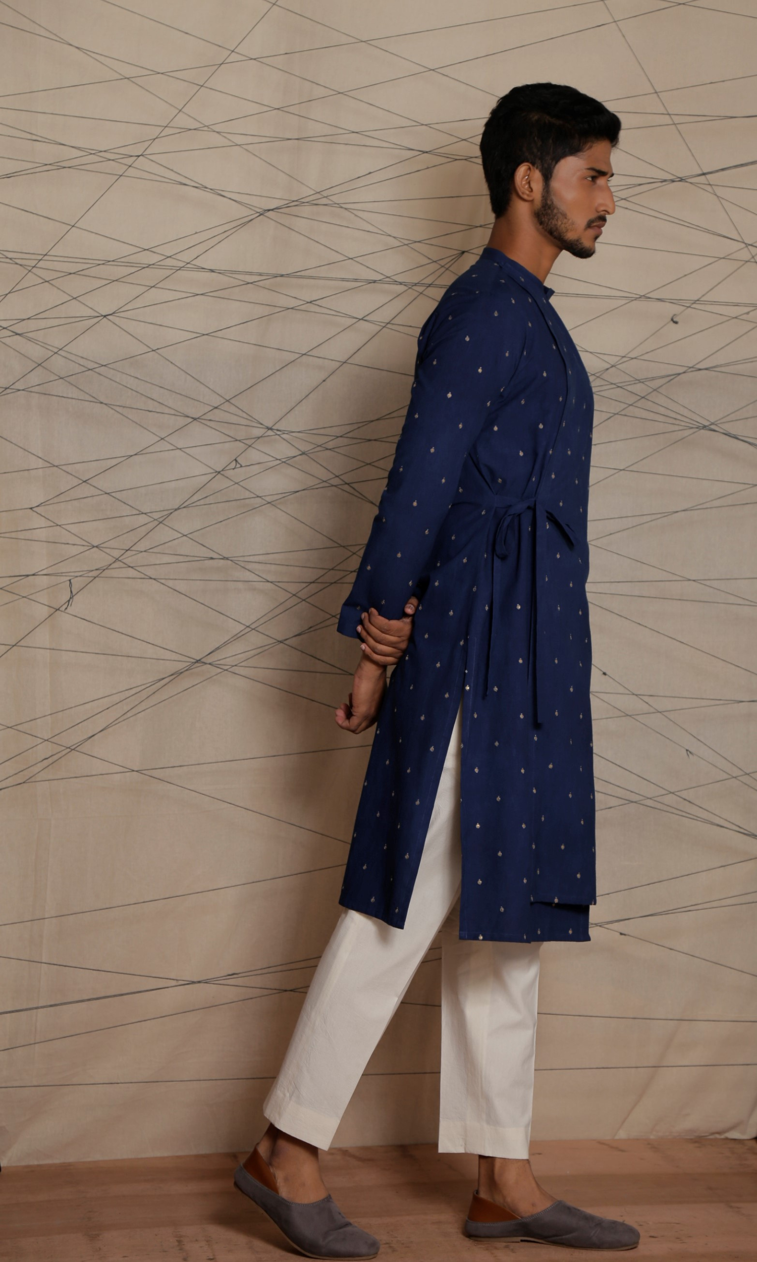 Dark blue asymmetrical tie up kurta with all over emb motifs