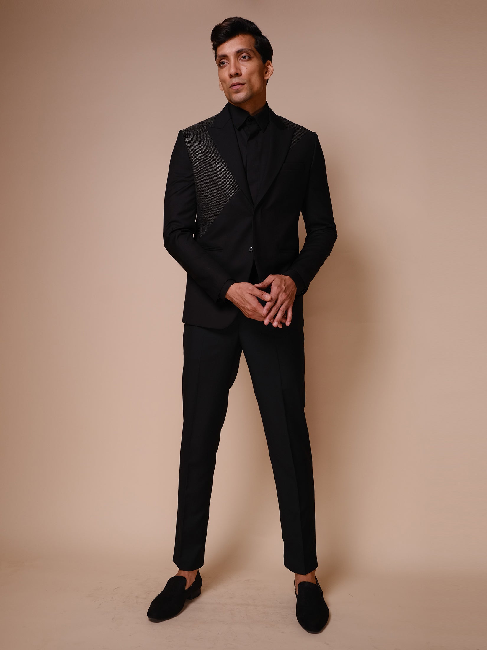 Black Peak Lapel Suit With Diagonal Gold Textured Lines Across Chest Paired With Trousers And Tonal Shirt