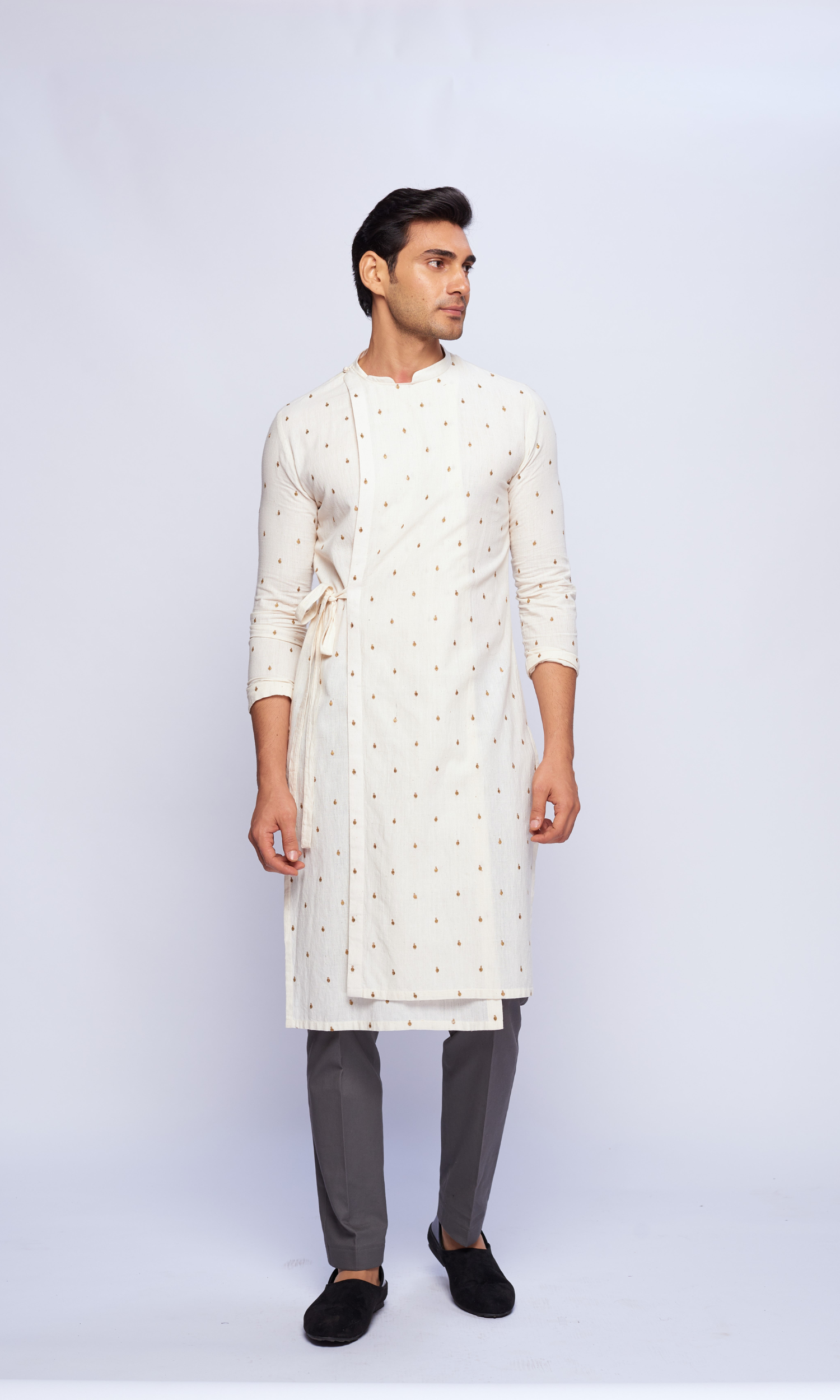 Off white asymmetrical tie up kurta with all over emb motifs