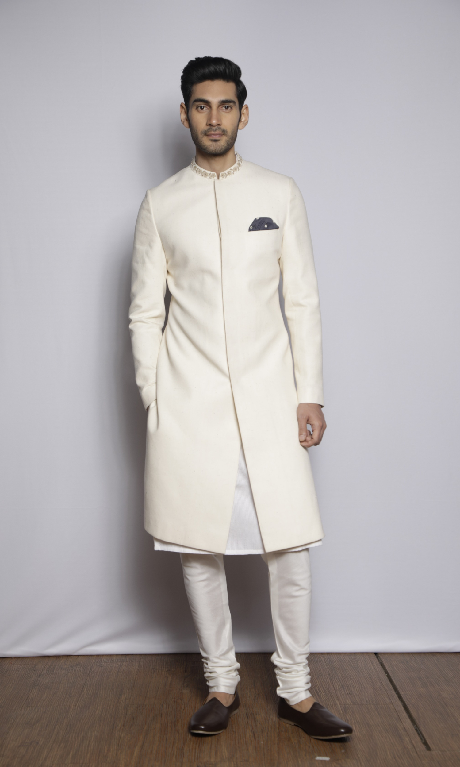 Off white sherwani with emb collar paired with front self threading kurta and churidar