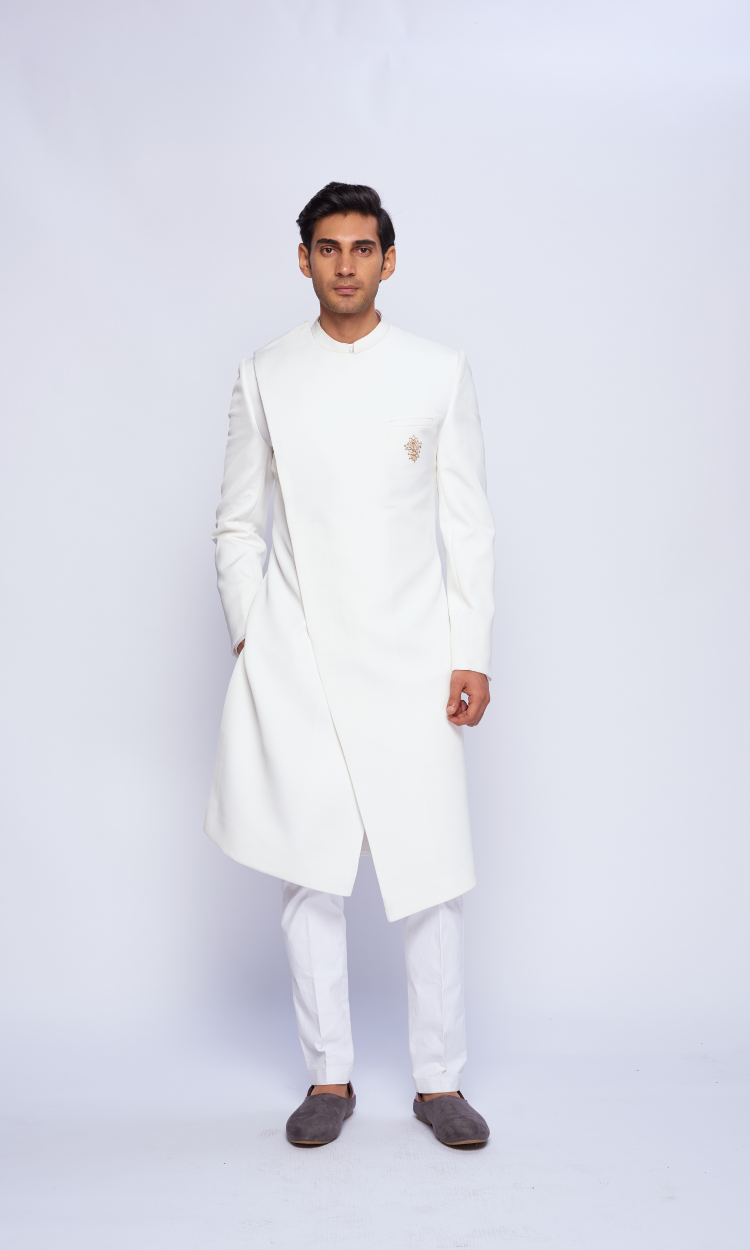 Off white overlap indowestern sherwani with dull gold emb motif on pocket and fitted pants
