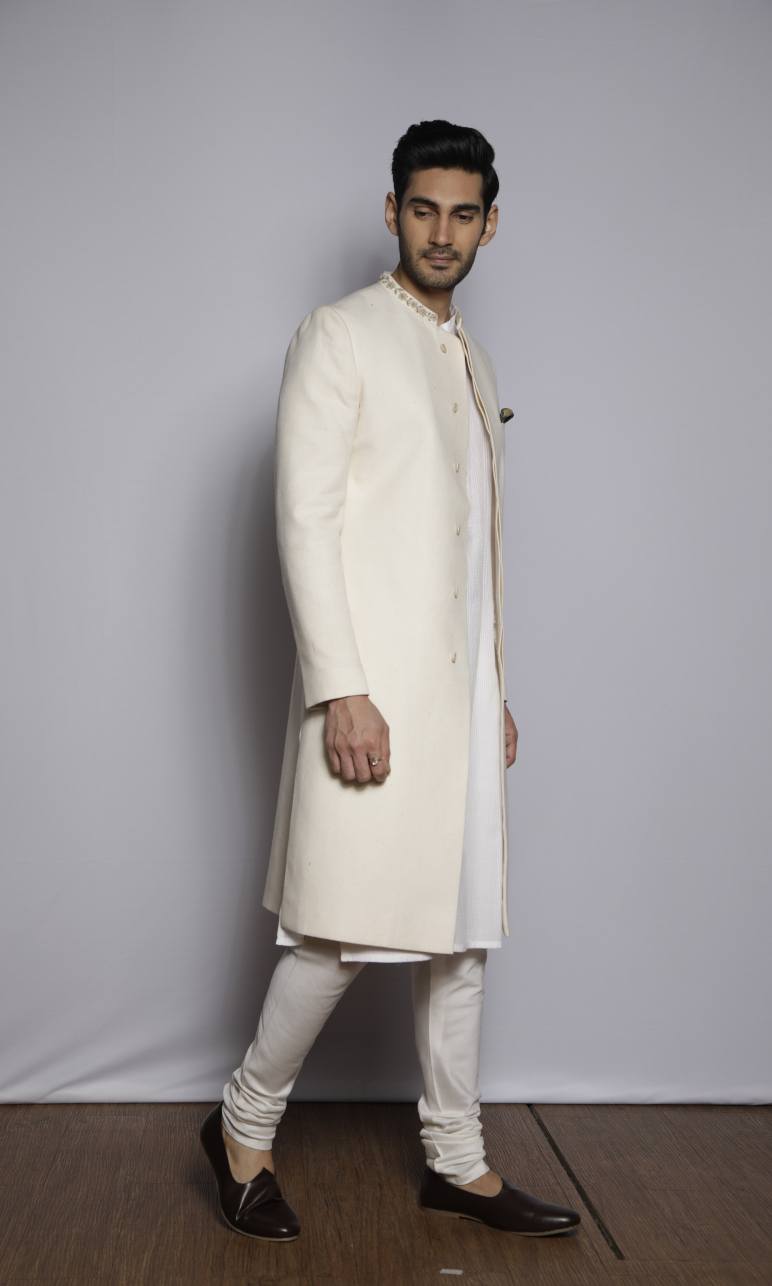 Off white sherwani with emb collar paired with front self threading kurta and churidar