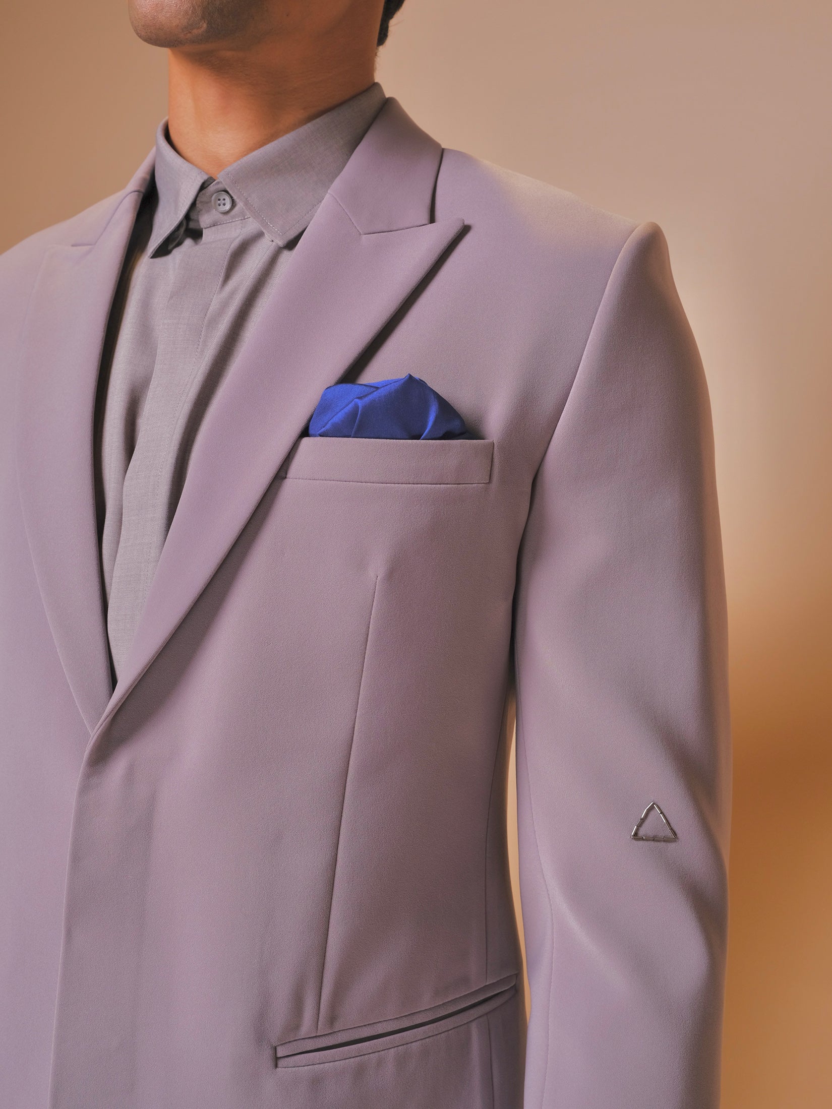 Grey Peak Shawl Lapel Suit With Embroidered Triangle Motif On Sleeves Paired With Trousers And Tonal Shirt